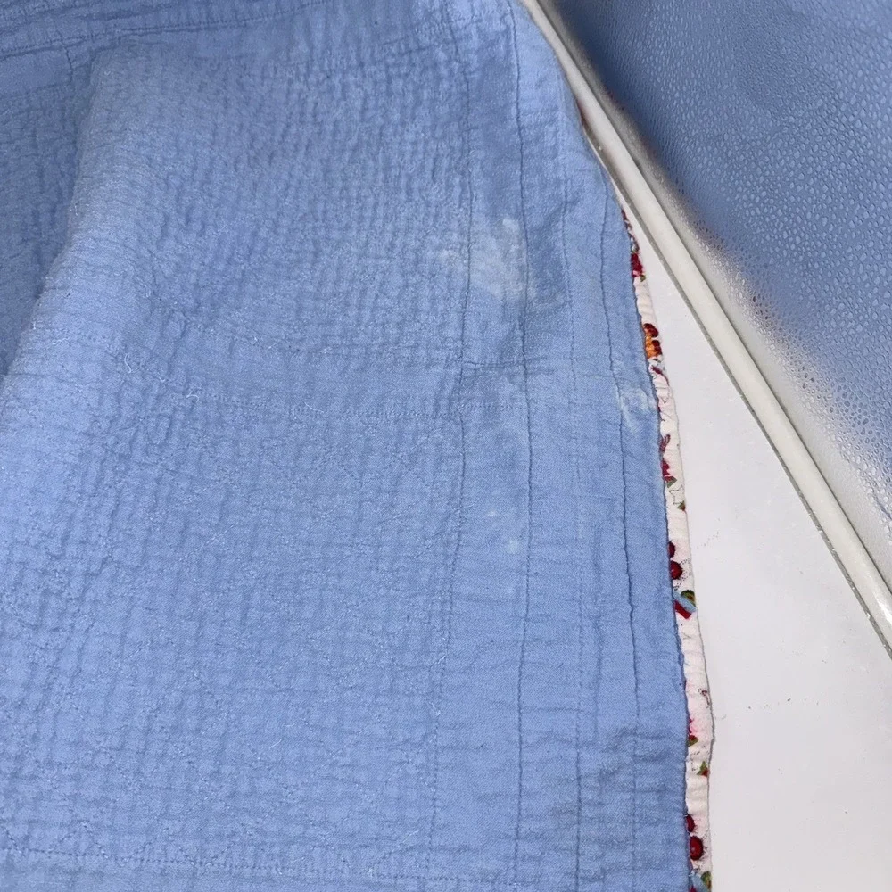 Vtg Baby Quilt Of Trains Print bordered by blue sashing and red cornerstones